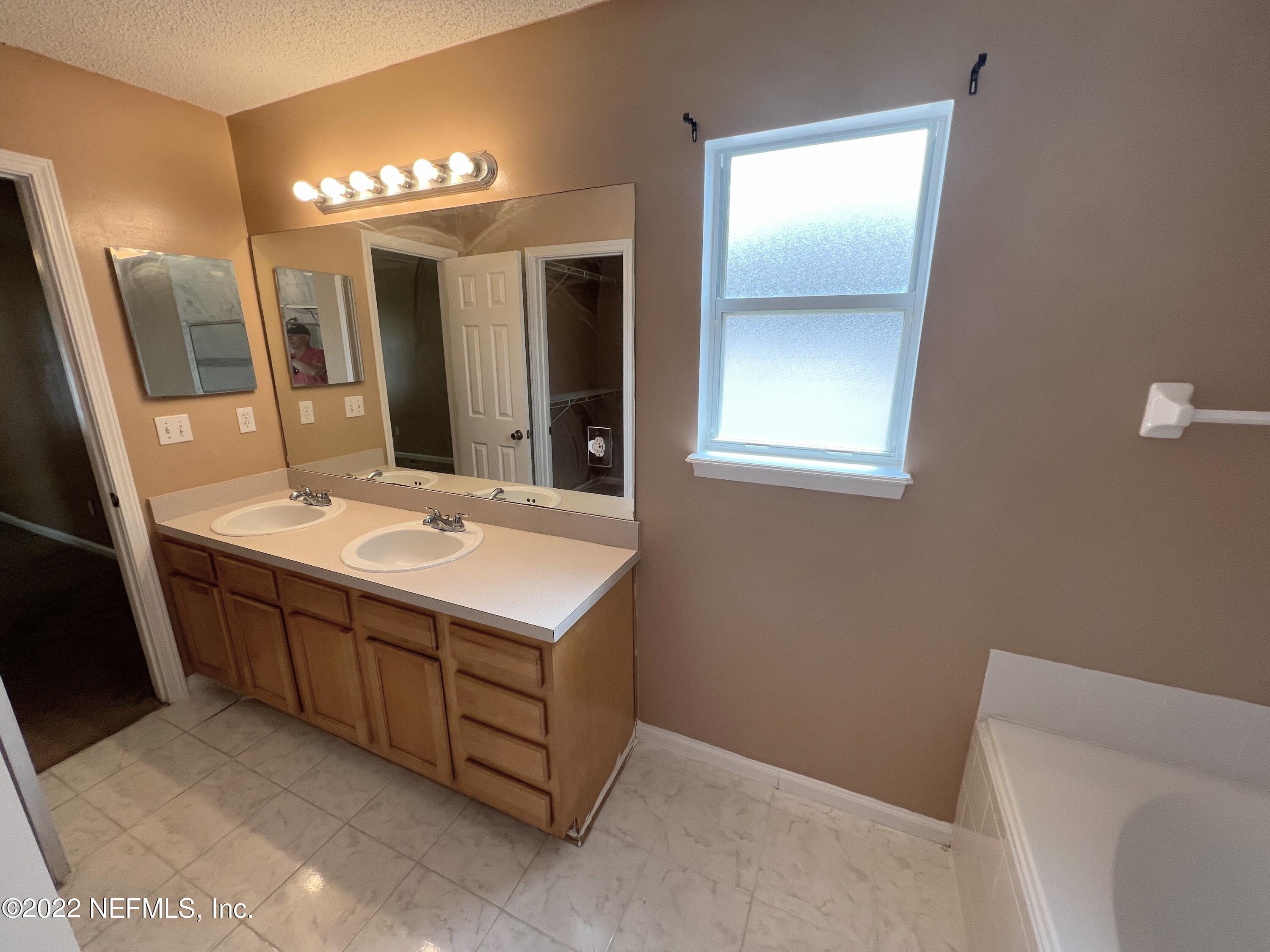 3742 Star Leaf Road West Jacksonville, FL 32210 - Photo 26 of 39 a bathroom with a double vanity sink and a mirror