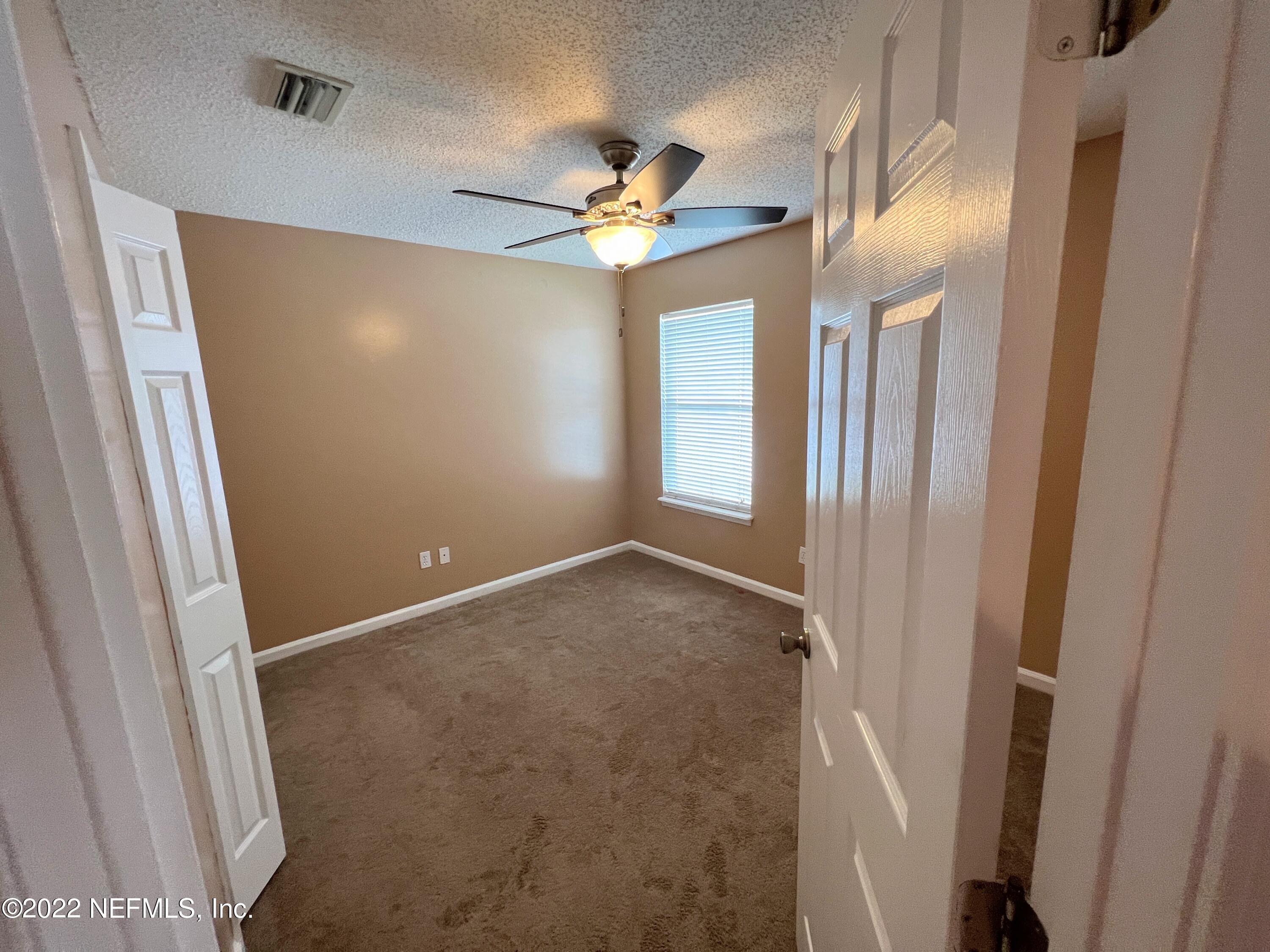 3742 Star Leaf Road West Jacksonville, FL 32210 - Photo 27 of 39 a view of a livingroom with a ceiling fan and window