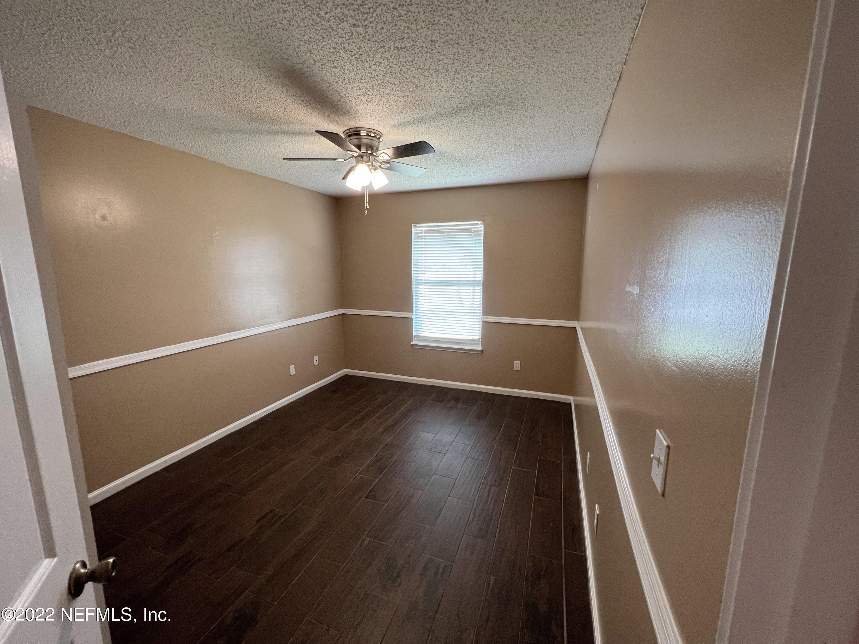 3742 Star Leaf Road West Jacksonville, FL 32210 - Photo 29 of 39 an empty room with wooden floor and windows