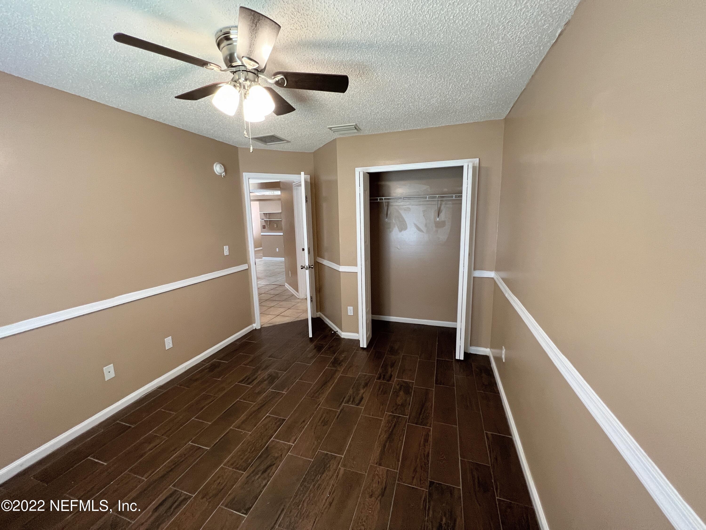 3742 Star Leaf Road West Jacksonville, FL 32210 - Photo 30 of 39 a view of an empty room with wooden floor