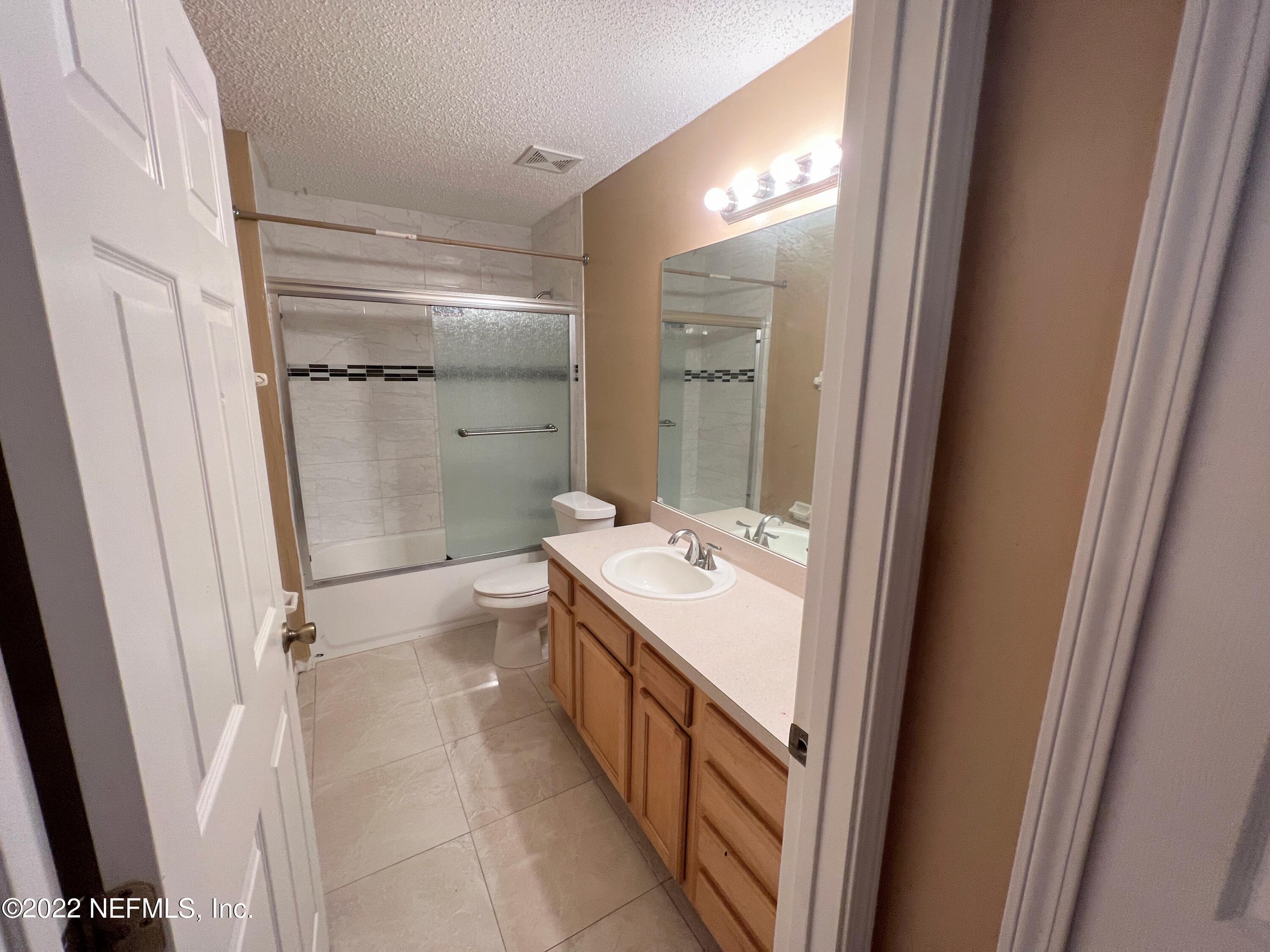 3742 Star Leaf Road West Jacksonville, FL 32210 - Photo 31 of 39 a bathroom with a double vanity sink toilet and shower