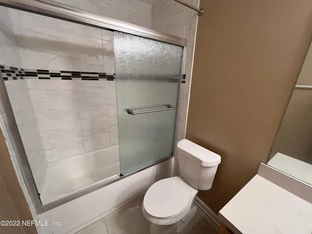 a white toilet sitting next to a bathroom sink