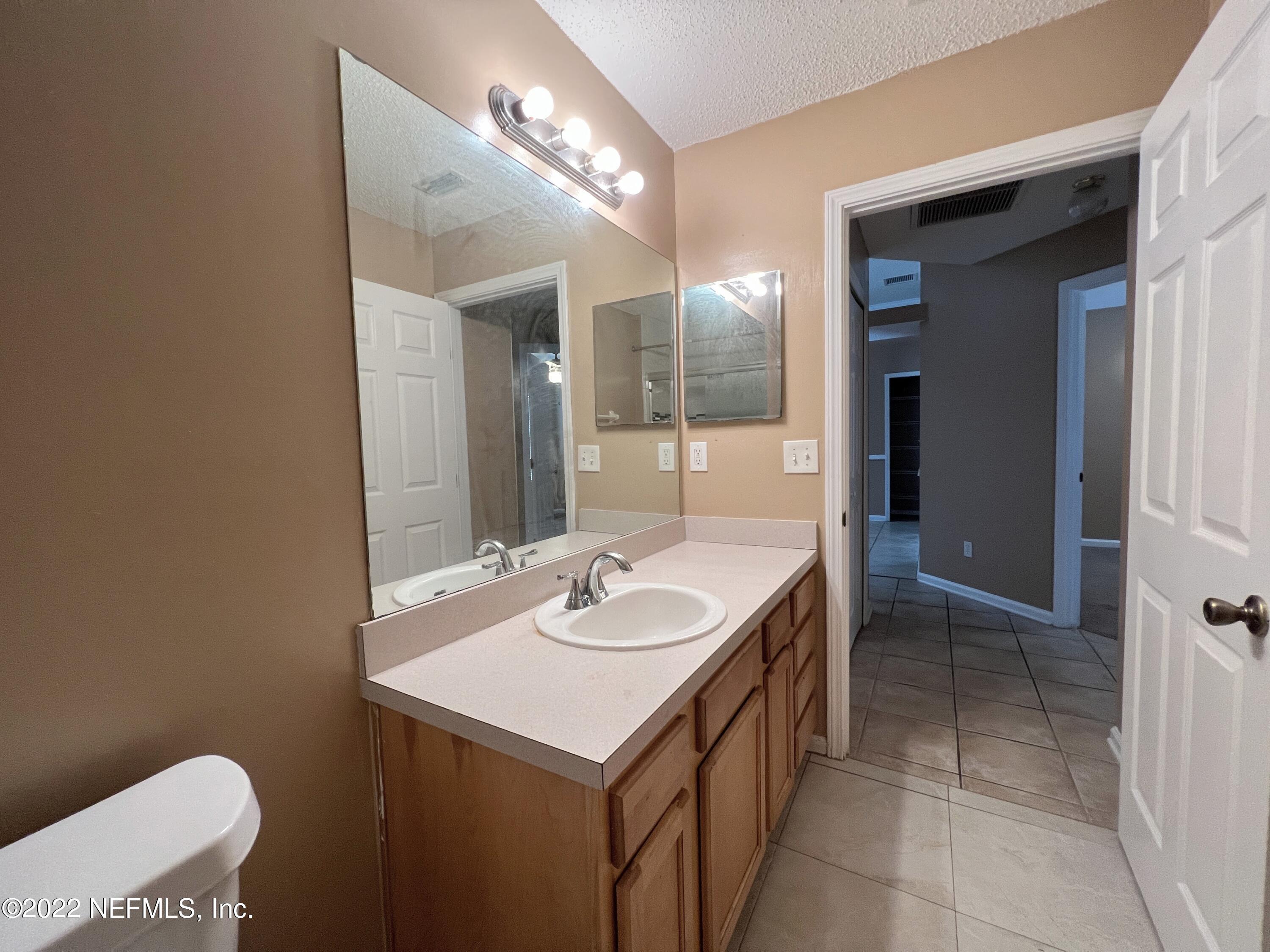 3742 Star Leaf Road West Jacksonville, FL 32210 - Photo 33 of 39 a bathroom with a sink and a mirror