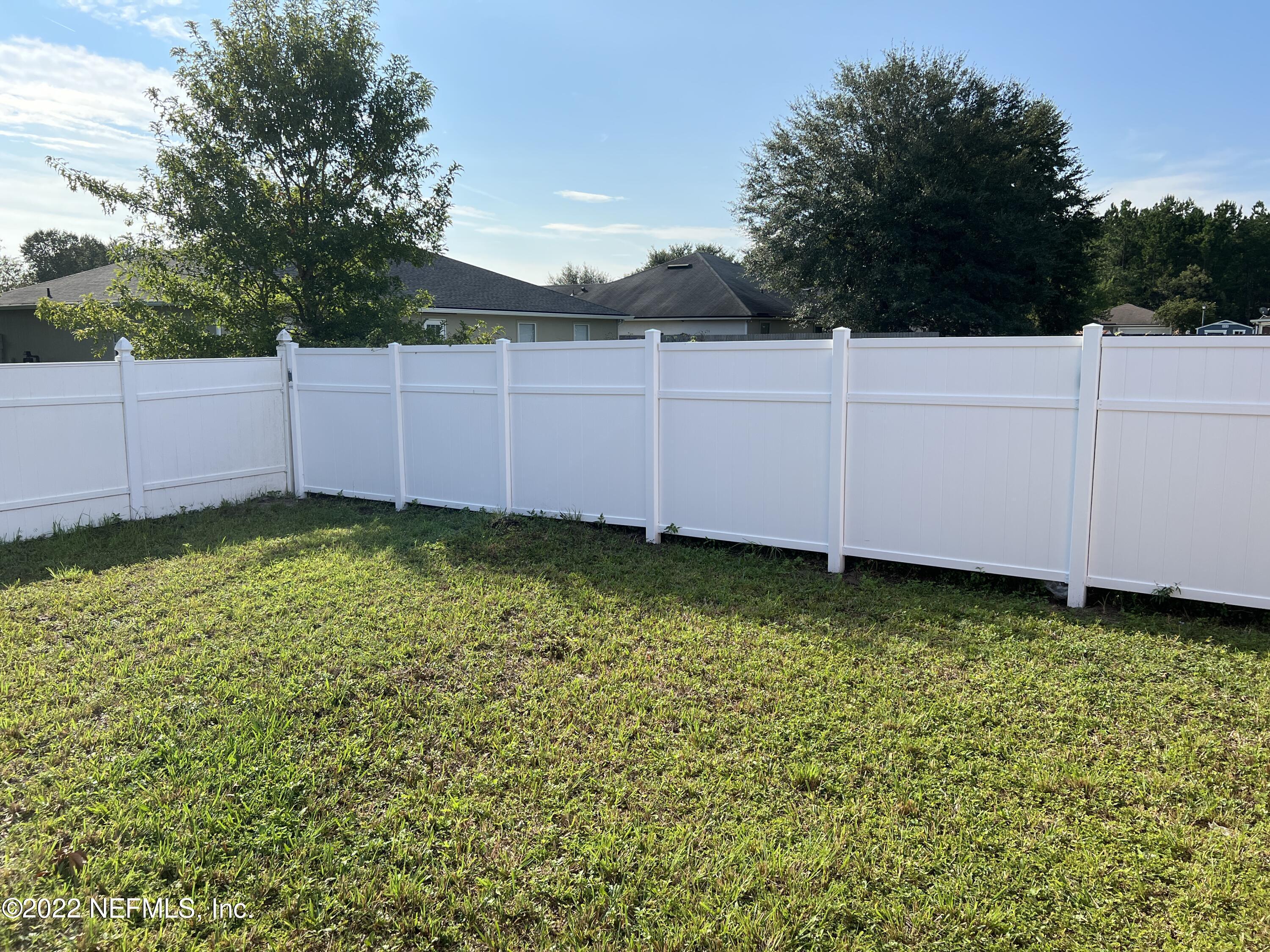 3742 Star Leaf Road West Jacksonville, FL 32210 - Photo 37 of 39 a view of a backyard with potted plants and wooden fence