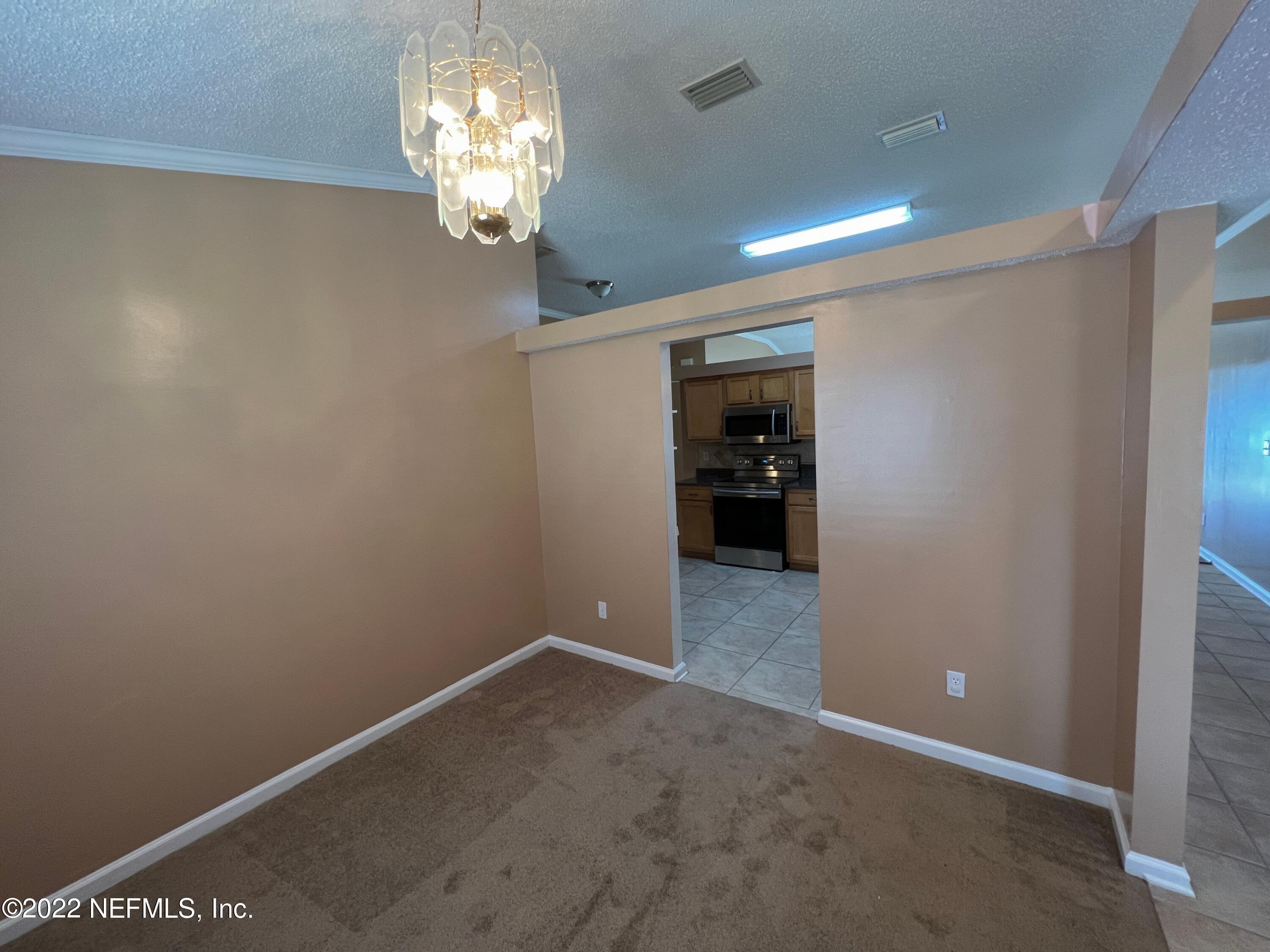3742 Star Leaf Road West Jacksonville, FL 32210 - Photo 8 of 39 a view of a chandelier in big room and chandelier