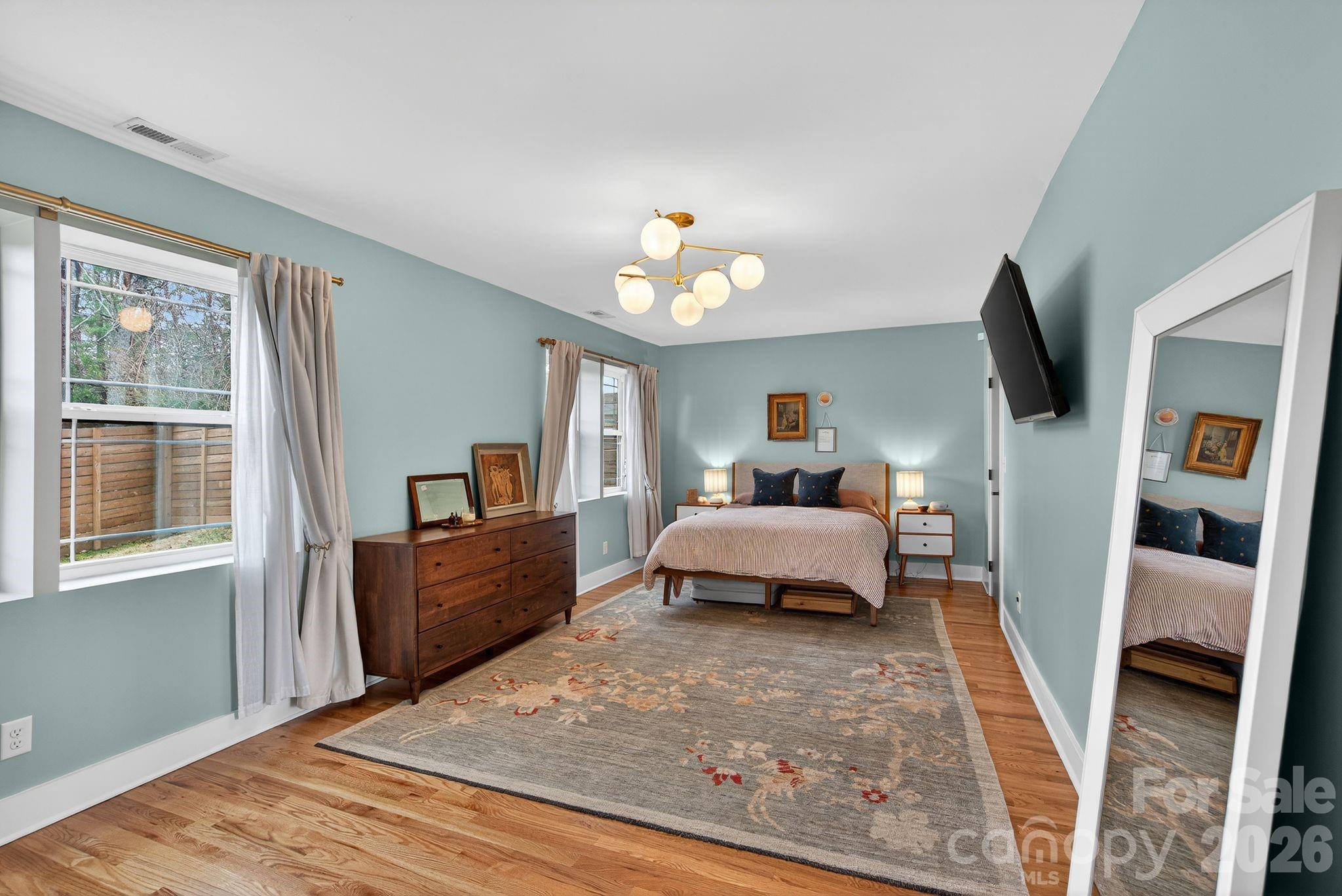 20 Bethesda Road Asheville, NC 28805 - Photo 15 of 30 a bedroom with a bed and wooden floor