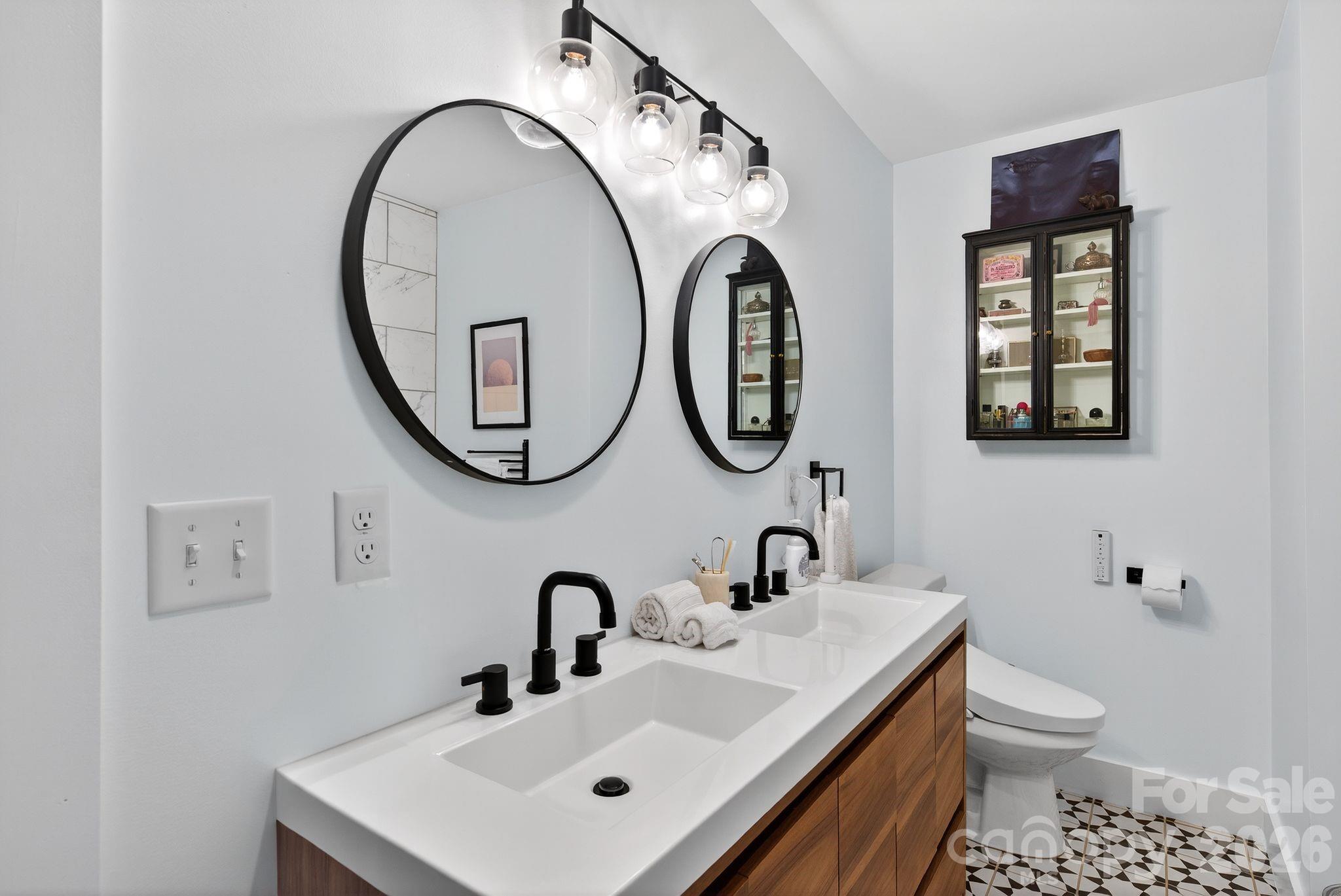 20 Bethesda Road Asheville, NC 28805 - Photo 17 of 30 a bathroom with a toilet a sink and a mirror