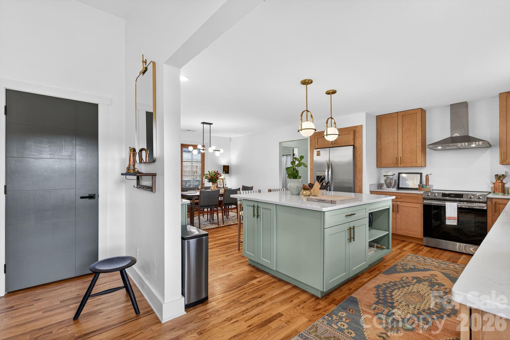 20 Bethesda Road Asheville, NC 28805 - Photo 4 of 30 a view of kitchen with stainless steel appliances kitchen island wooden floors and living room view
