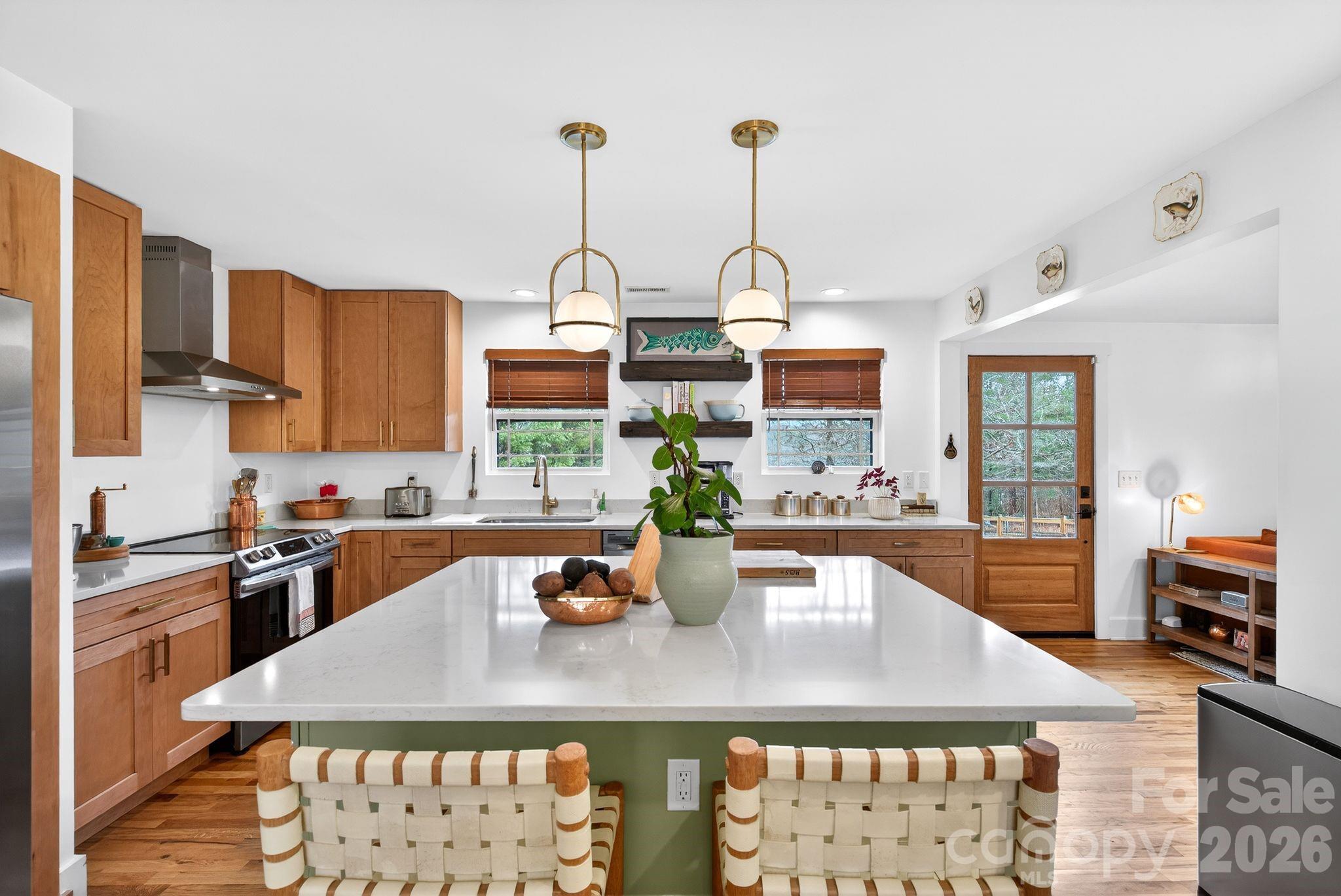 20 Bethesda Road Asheville, NC 28805 - Photo 5 of 30 a kitchen with stainless steel appliances a kitchen island a stove a table and chairs