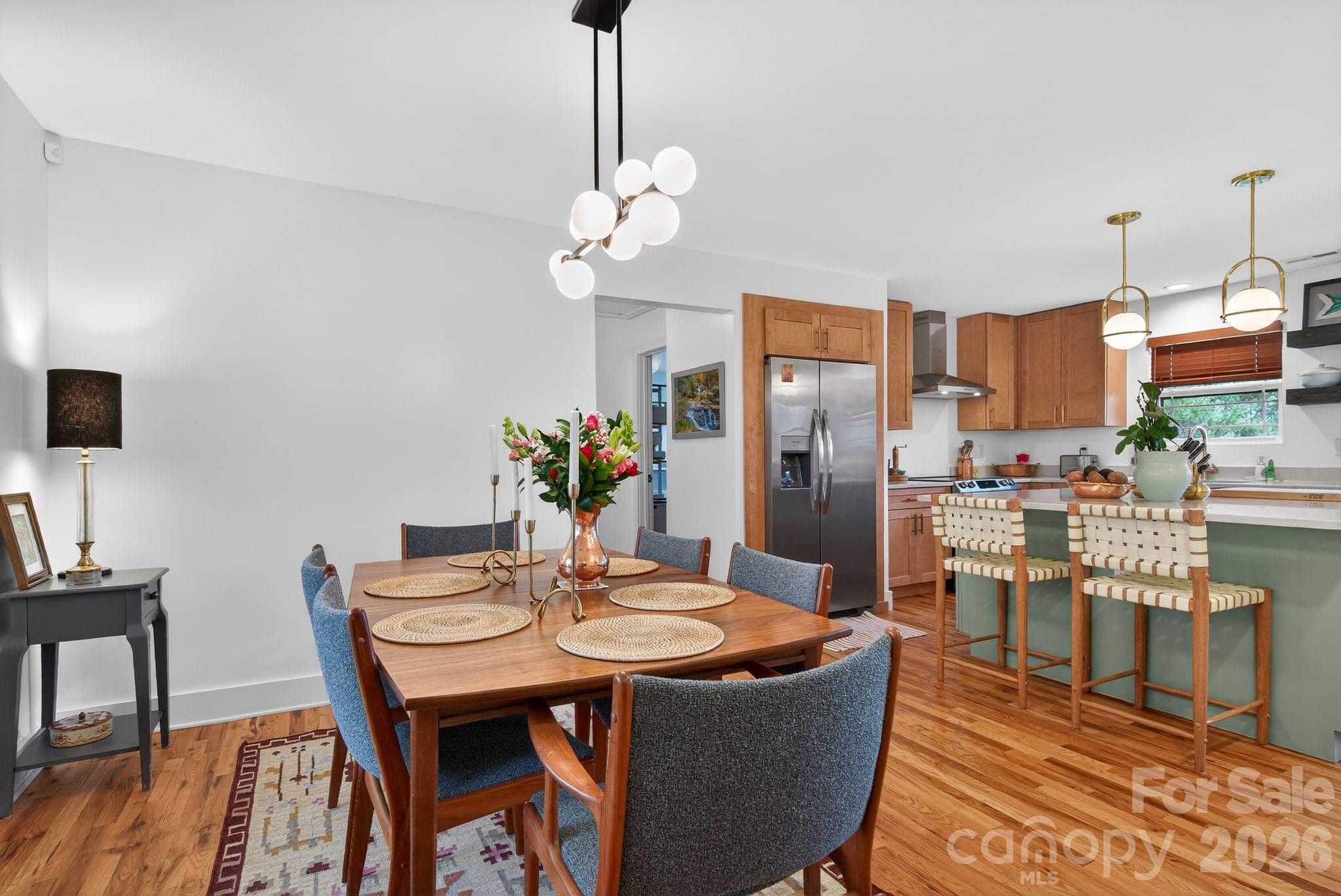 20 Bethesda Road Asheville, NC 28805 - Photo 9 of 30 a dining room with furniture a kitchen and chandelier