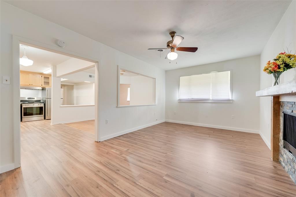 1104 Trinity View Street Irving, TX 75060 - Photo 14 of 34 a view of an empty room with a window and wooden floor