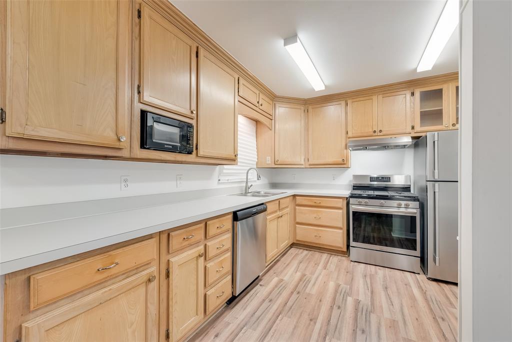 1104 Trinity View Street Irving, TX 75060 - Photo 16 of 34 a kitchen with stainless steel appliances granite countertop a stove and a microwave
