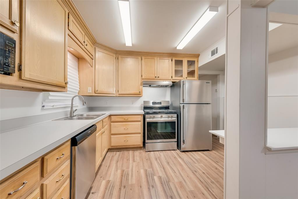 1104 Trinity View Street Irving, TX 75060 - Photo 18 of 34 a kitchen with a sink stove and refrigerator