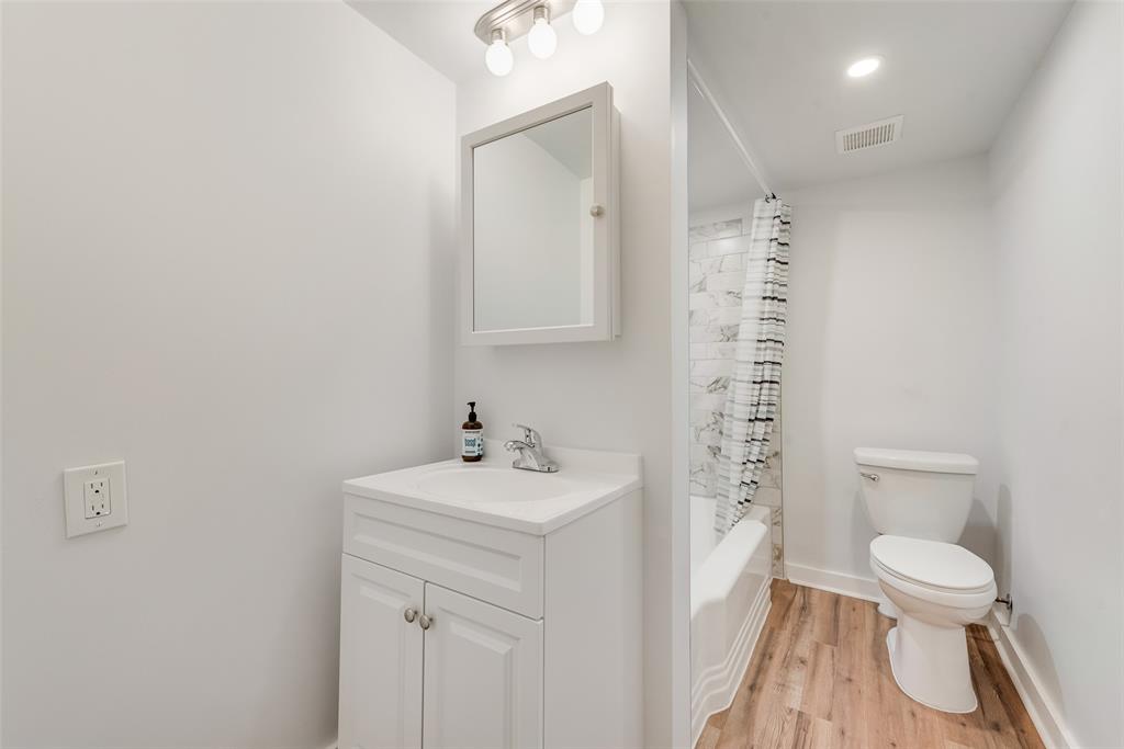 1104 Trinity View Street Irving, TX 75060 - Photo 20 of 34 a white toilet sitting next to a bathroom sink