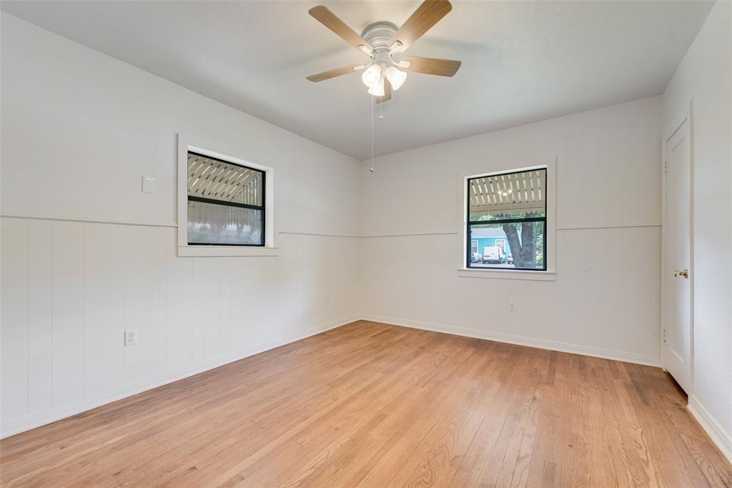 1104 Trinity View Street Irving, TX 75060 - Photo 21 of 34 a view of a big room with wooden floor and a ceiling fan
