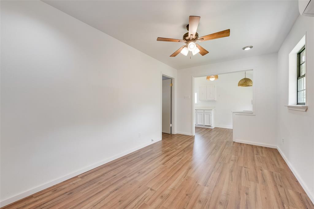1104 Trinity View Street Irving, TX 75060 - Photo 25 of 34 a view of an empty room with wooden floor and a ceiling fan
