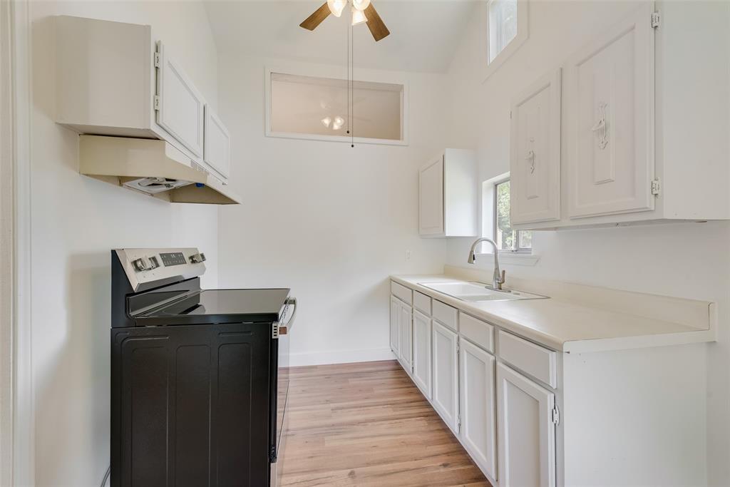 1104 Trinity View Street Irving, TX 75060 - Photo 28 of 34 a kitchen with stainless steel appliances a sink and a refrigerator