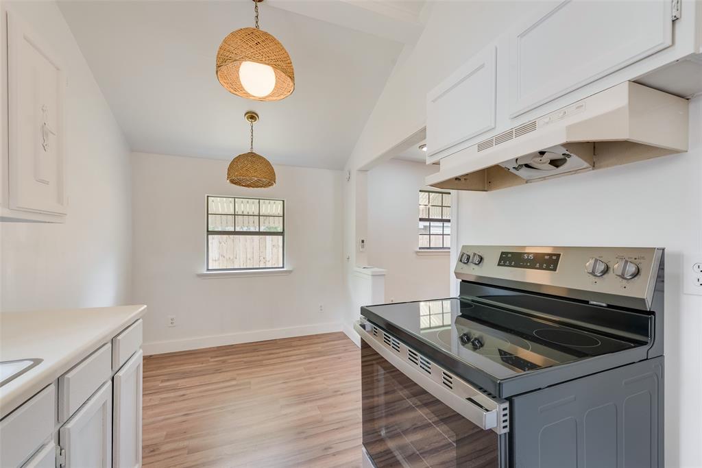 1104 Trinity View Street Irving, TX 75060 - Photo 29 of 34 a kitchen that has a stove and a wooden floor