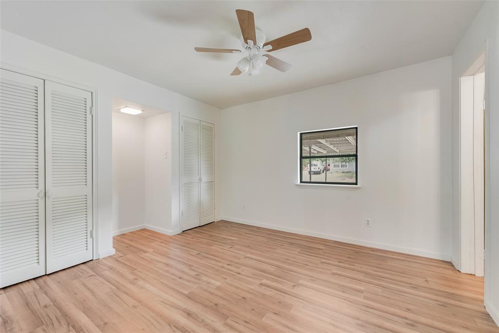 1104 Trinity View Street Irving, TX 75060 - Photo 30 of 34 a view of a big room with wooden floor and a ceiling fan