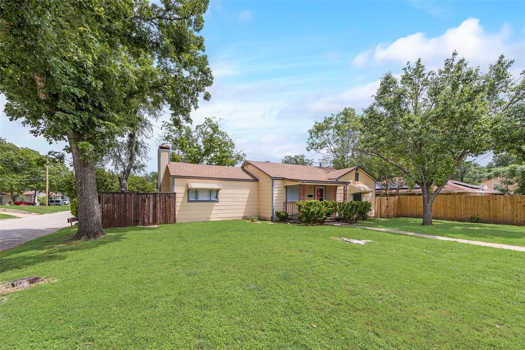 1104 Trinity View Street Irving, TX 75060 - Photo 4 of 34 a front view of a house with a yard and trees