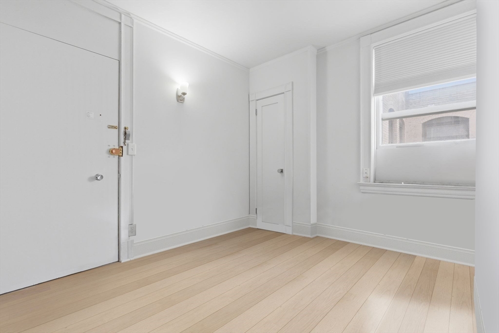 21 Beacon Street, Unit 11L Boston, MA 02108 - Photo 4 of 23 a view of empty room with wooden floor