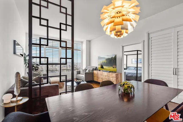 a view of a dining room with furniture and chandelier