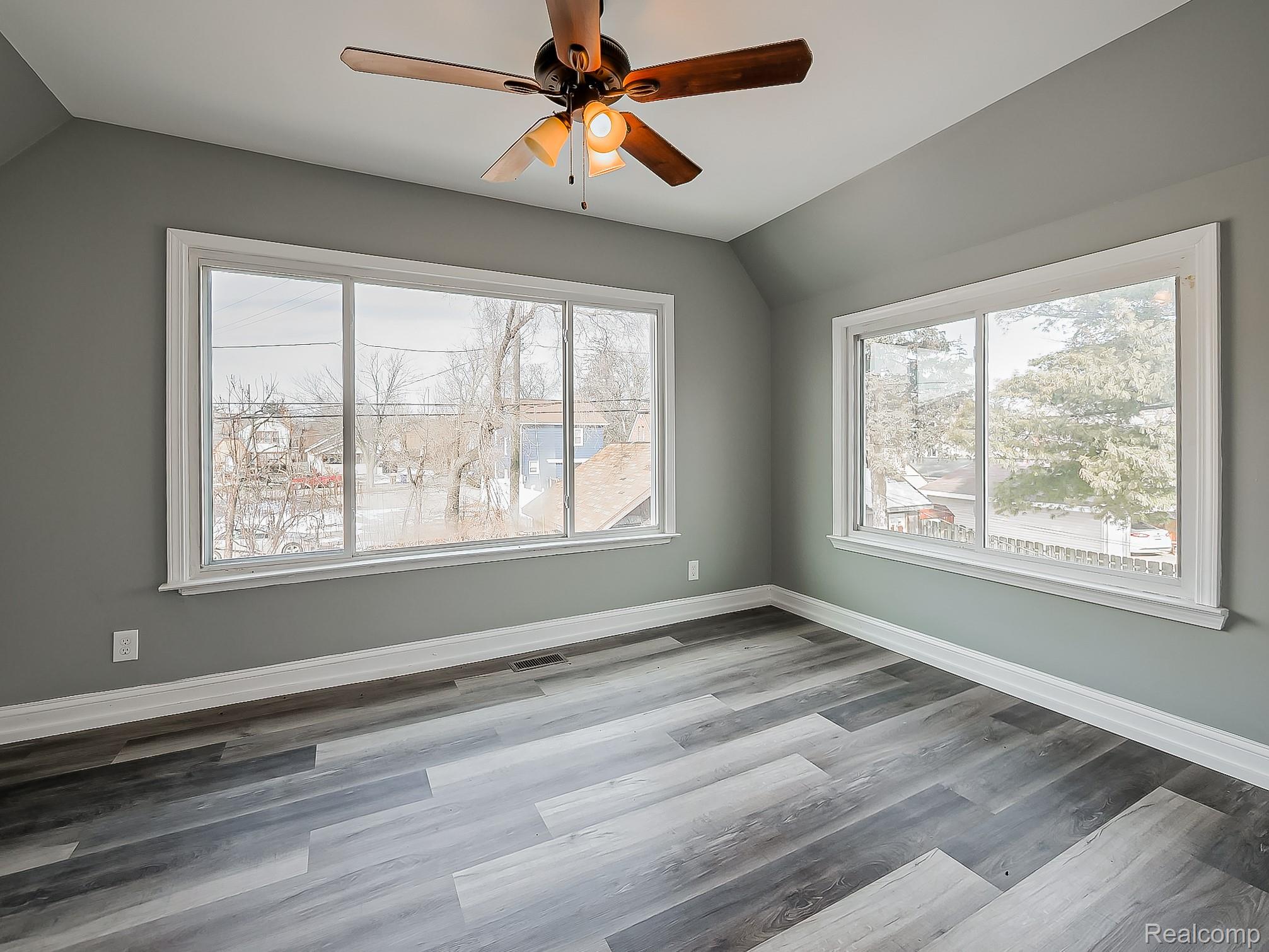 13 Mohawk Road Pontiac, MI 48341 - Photo 10 of 24 Spare room featuring a ceiling fan, lofted ceiling, light wood-style flooring, and plenty of natural light