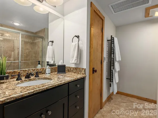 a bathroom with a granite countertop sink and a mirror