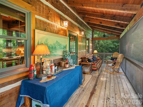 a view of a balcony with chairs and wooden floor