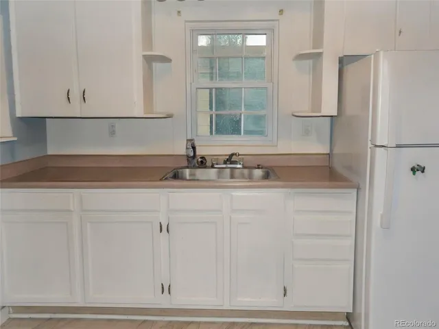 a bathroom with a sink and cabinets