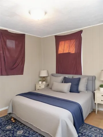 a bedroom with a bed and window