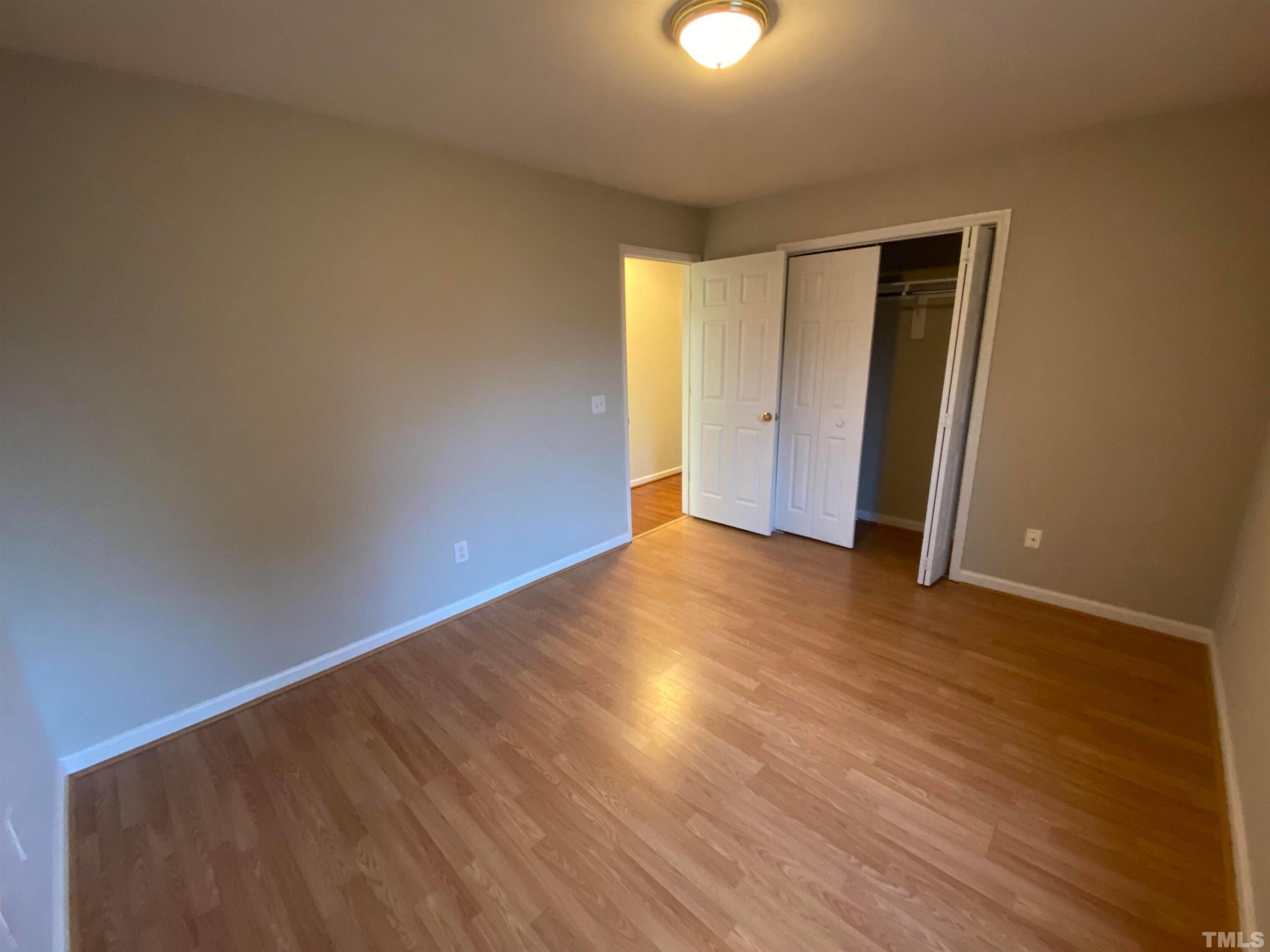 2413 Wellington Ridge Loop, Unit 2413 Cary, NC 27518 - Photo 18 of 30 a view of an empty room with wooden floor
