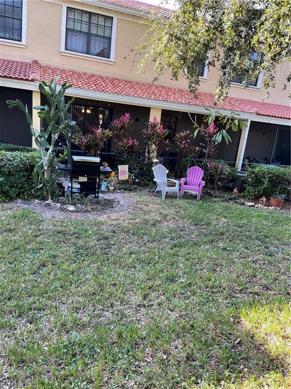 14908 Summit Pl Circle, Unit 26 Naples, FL 34119 - Photo 3 of 32 a view of a chairs and a table in a patio