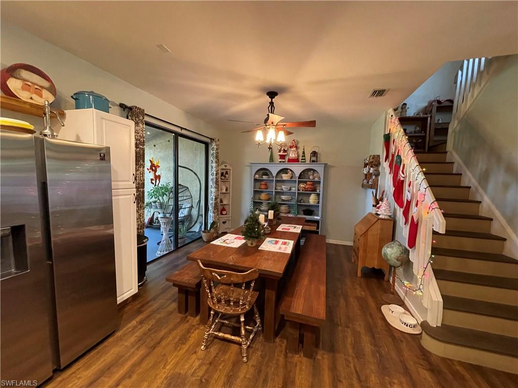 14908 Summit Pl Circle, Unit 26 Naples, FL 34119 - Photo 7 of 32 a view of a dining room with furniture and wooden floor