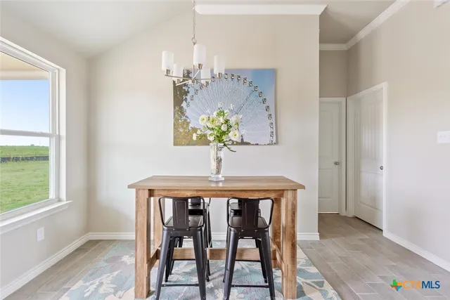 a dining room that has a table and a chandelier