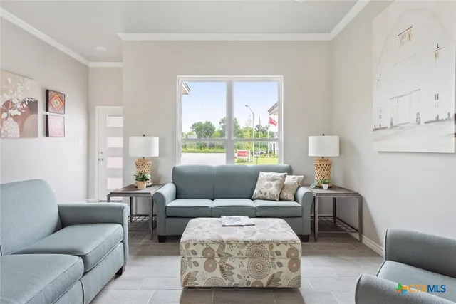 a living room with furniture and a large window