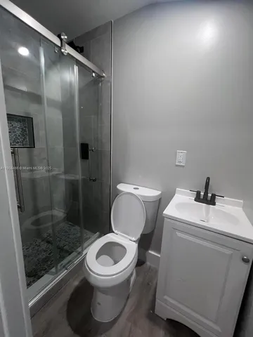 a bathroom with a toilet a sink and a shower