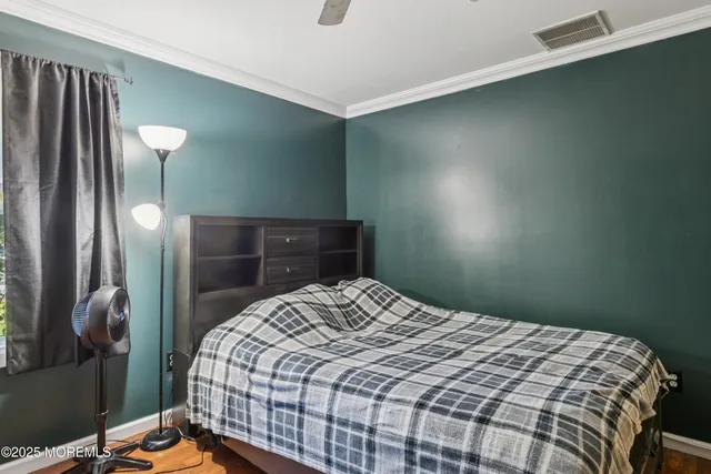 a bedroom with a bed and a lamp