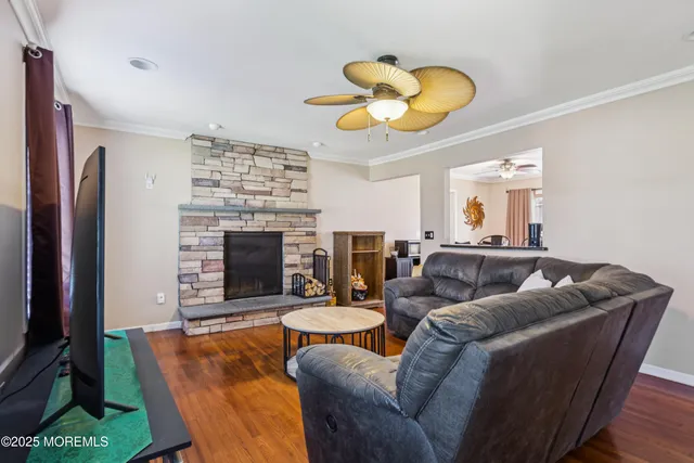 a living room with furniture a fireplace and a large window