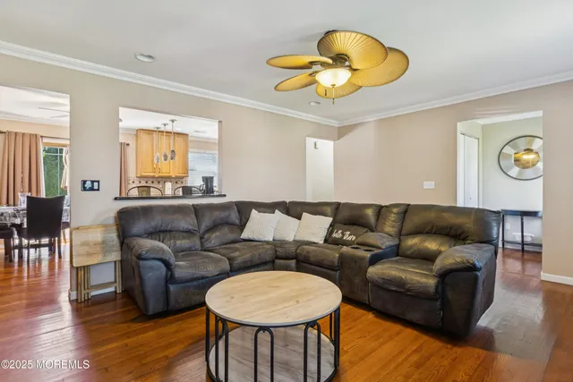 a living room with furniture a lamp and a large window
