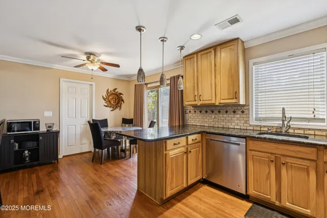 a view of a kitchen counter space dining table and chairs