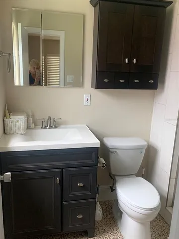 a bathroom with a sink toilet and mirror