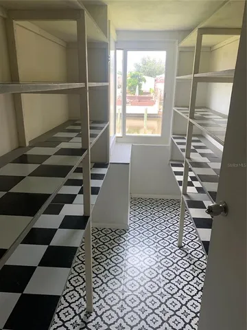 a room with a black white checkered floor with a black white checkered floor and a chair