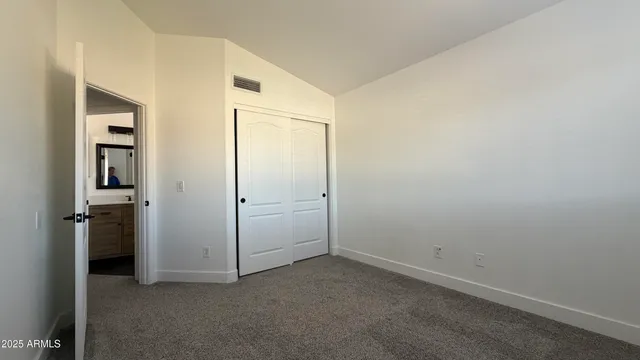 a bathroom with a toilet a sink a mirror and a shower