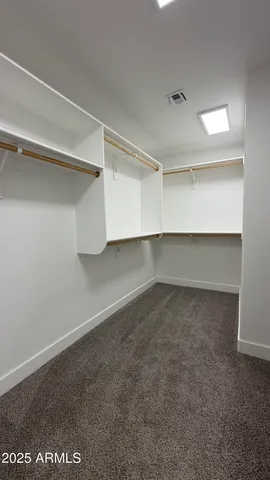 a kitchen with sink a refrigerator and wooden floor