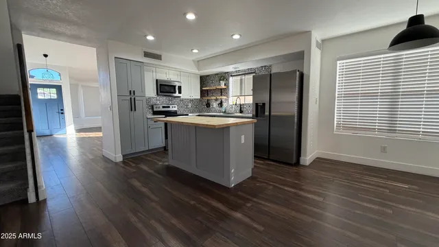 a view of a kitchen with furniture and wooden floor