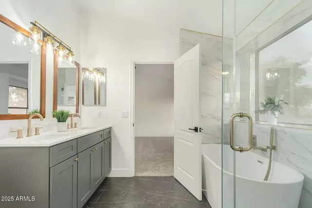 a bathroom with a double vanity sink toilet and shower