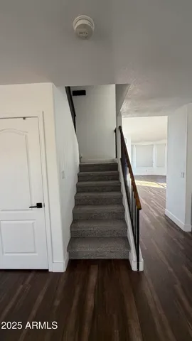 an empty room with wooden floor and door