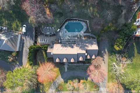 a view of a fountain in the yard next to a house
