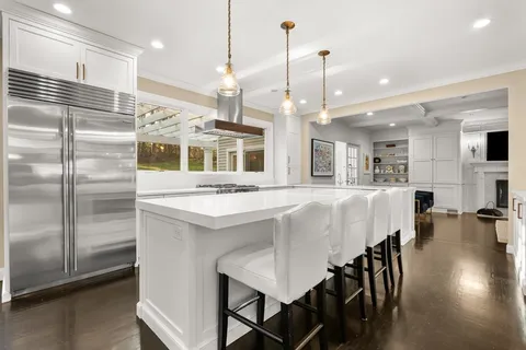 a large kitchen with a table and chairs